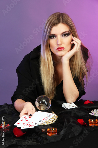 Photo: Witch - fortune teller on color background Witch - fortune teller on color background