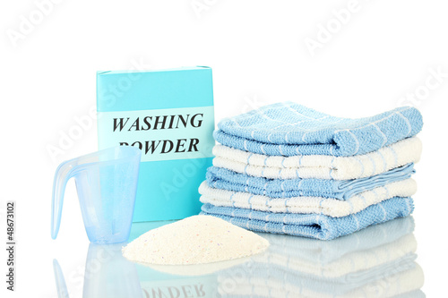Photo: Box of washing powder with blue measuring cup and towels, Box of washing powder with blue measuring cup and towels,