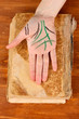 Chiromancy.Color contours on palm, on wooden background