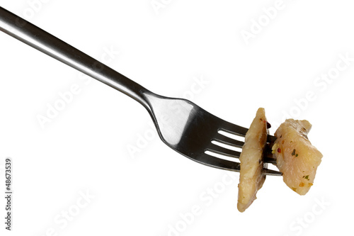 Photo: Pieces of herring on fork isolated on white Pieces of herring on fork isolated on white
