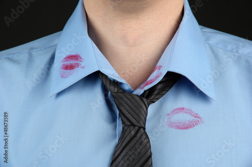 Photo: Lipstick kiss on shirt collar of man, isolated on black Lipstick kiss on shirt collar of man, isolated on black