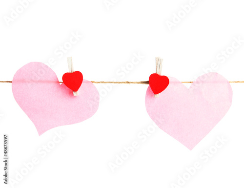 Photo: two paper hearts on rope, isolated on white two paper hearts on rope, isolated on white