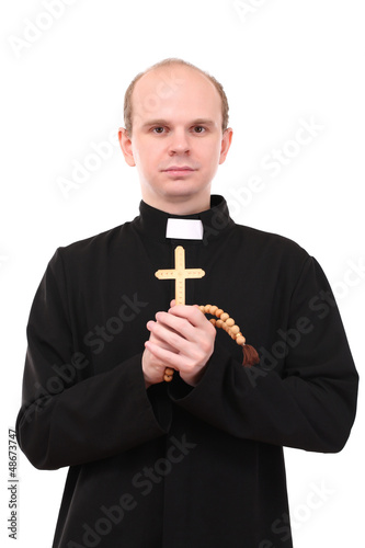 Photo: Young pastor with wooden cross and rosary, isolated on white Young pastor with wooden cross and rosary, isolated on white