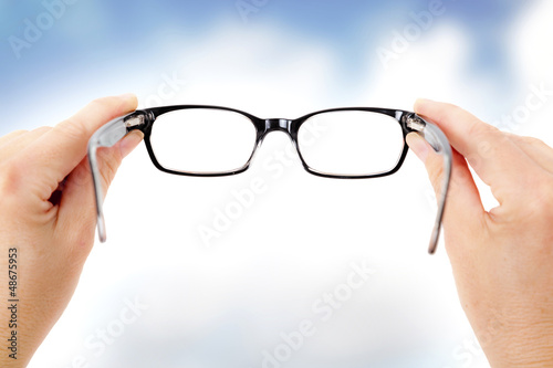 Photo: Hand holding glasses Hand holding glasses