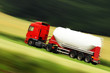 large white cistern truck speeding on highway