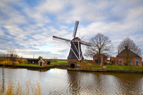 Photo: Dutch windmill by canal Dutch windmill by canal