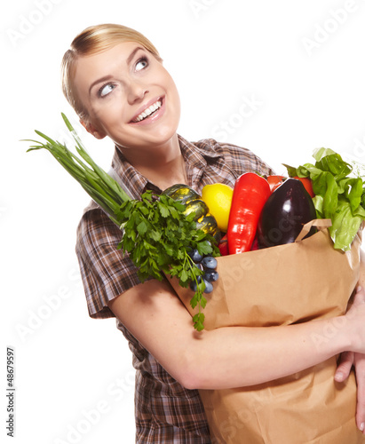 Photo: woman holding a shopping bag full of groceries, mango, salad, r woman holding a shopping bag full of groceries, mango, salad, r