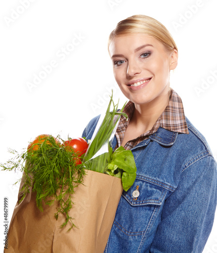 Photo: woman holding a shopping bag full of groceries, mango, salad, r woman holding a shopping bag full of groceries, mango, salad, r