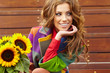 Fashion woman with sunflower at outdoor.