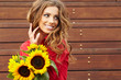 Fashion woman with sunflower at outdoor.