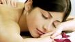 Beautiful woman in spa receiving back massage