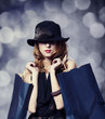 Style redhead girl with shopping bags.