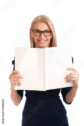 Photo: Young woman reading womens magazine Young woman reading womens magazine