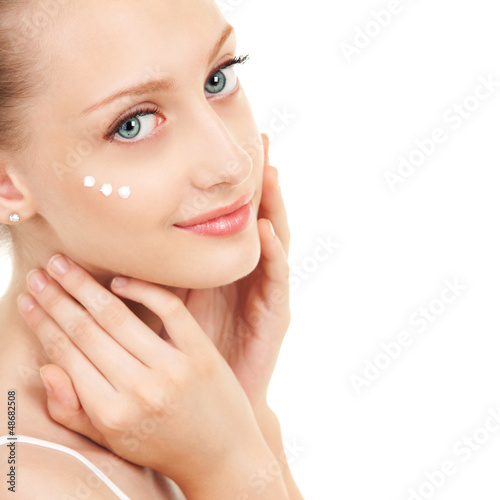 Photo: Cute woman applying cream to her face Cute woman applying cream to her face