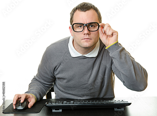 Photo: Man using computer at desk Man using computer at desk