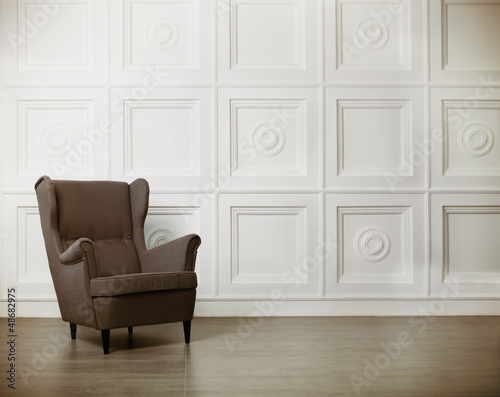 Photo: One classic armchair against a white wall and floor One classic armchair against a white wall and floor
