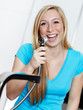 Young woman has fun at the kitchen sink with the tap