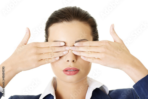 Photo: Attractive businesswoman covering her eyes Attractive businesswoman covering her eyes