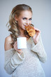 Woman enjoying a fresh crispy croissant