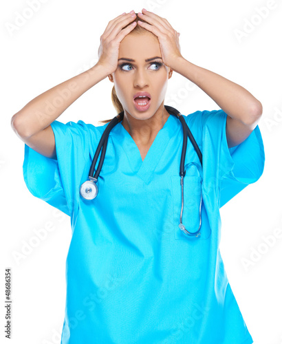 Photo: Distressed doctor holding her head Distressed doctor holding her head