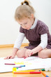 Cute little girl drawing with pencil