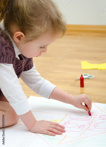 Photo: Cute little girl drawing with pencil Cute little girl drawing with pencil