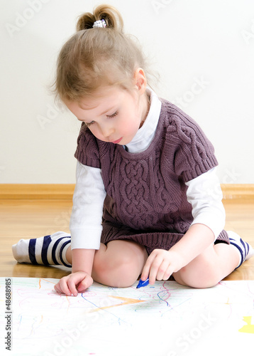 Photo: Cute little girl drawing with pencil Cute little girl drawing with pencil