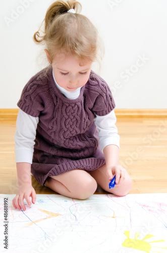 Photo: Cute little girl drawing with pencil Cute little girl drawing with pencil