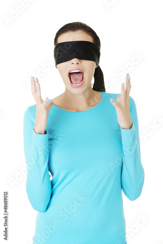 Photo: Beautiful frighten young blindfold woman screaming Beautiful frighten young blindfold woman screaming