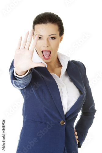Photo: Serious business woman making stop sign Serious business woman making stop sign