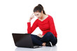 Woman sitting and working on laptop
