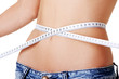 Young woman measuring her waist