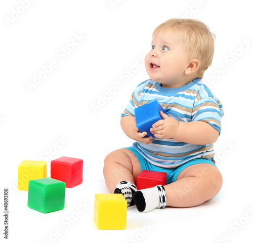 Photo: Little boy playing with multicolor blocks Little boy playing with multicolor blocks
