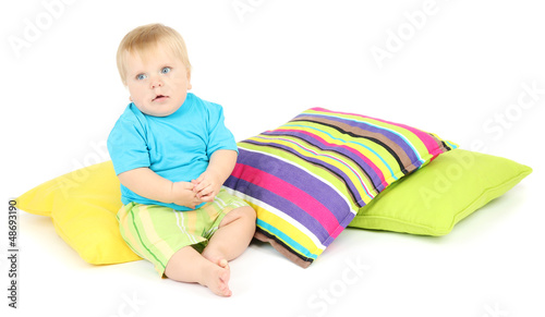 Photo: Little boy and color pillows, isolated on white Little boy and color pillows, isolated on white