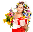 Woman with gift box and flower bouquet .