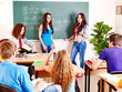 Group student near blackboard.