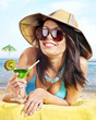 Photo: Girl in bikini drinking alcohol coctail through a straw. Girl in bikini drinking alcohol coctail through a straw.