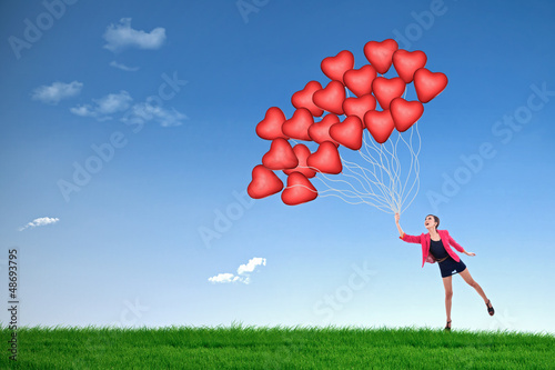 Photo: Girl hold red heart balloons Girl hold red heart balloons