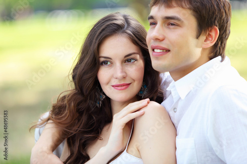 Photo: Young love Couple smiling under blue sky Young love Couple smiling under blue sky
