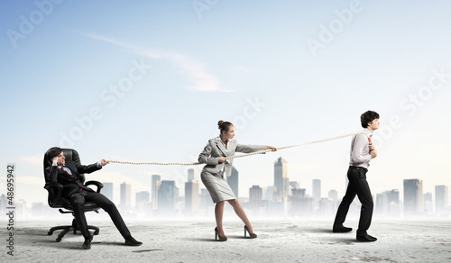 Photo: Three business people pulling rope Three business people pulling rope