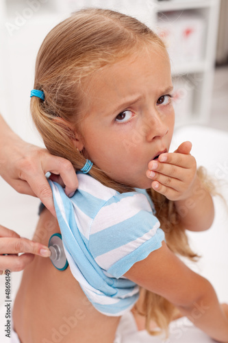 Photo: Coughing little girl at the doctors Coughing little girl at the doctors