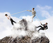 Three business people pulling rope
