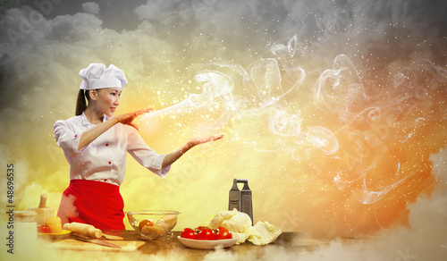 Photo: Asian female cooking with magic Asian female cooking with magic