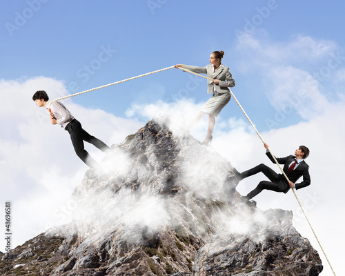 Photo: Three business people pulling rope Three business people pulling rope