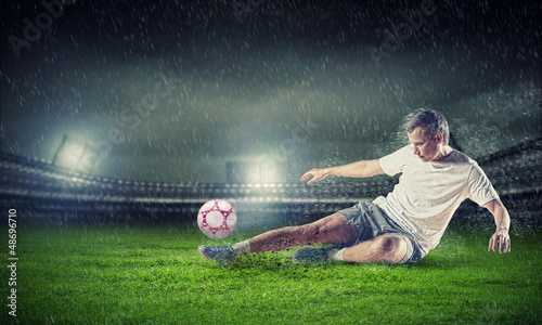 Photo: football player striking the ball football player striking the ball