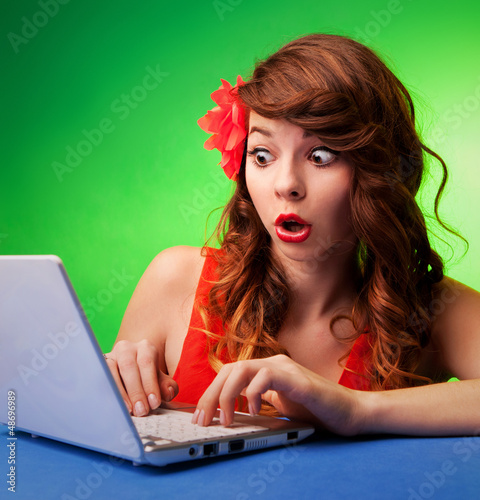 Photo: Surprised young woman at a computer Surprised young woman at a computer