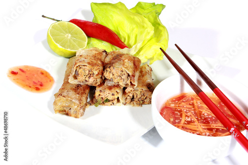 Photo: crispy springrolls on dish with salad isolated on the white crispy springrolls on dish with salad isolated on the white