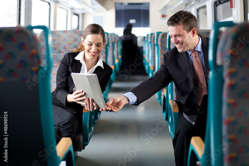 Photo: Businesswoman showing her colleague something on her tablet comp Businesswoman showing her colleague something on her tablet comp