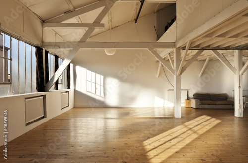 Photo: wide room of loft, beams and wooden floor wide room of loft, beams and wooden floor