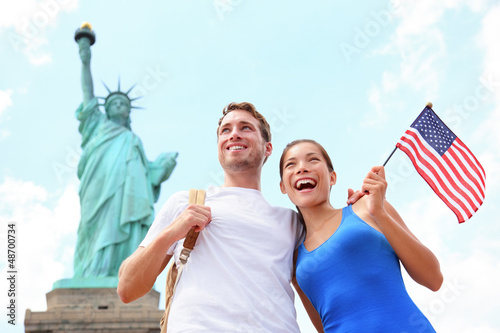 Photo: Tourists travel couple at Statue of Liberty, USA Tourists travel couple at Statue of Liberty, USA